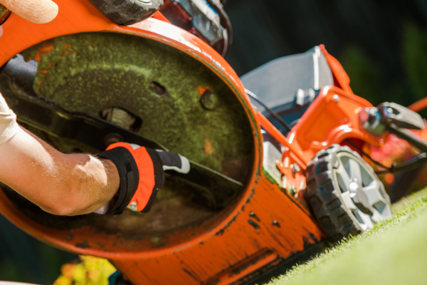 Lawn mower blades being looked at by a landscaper