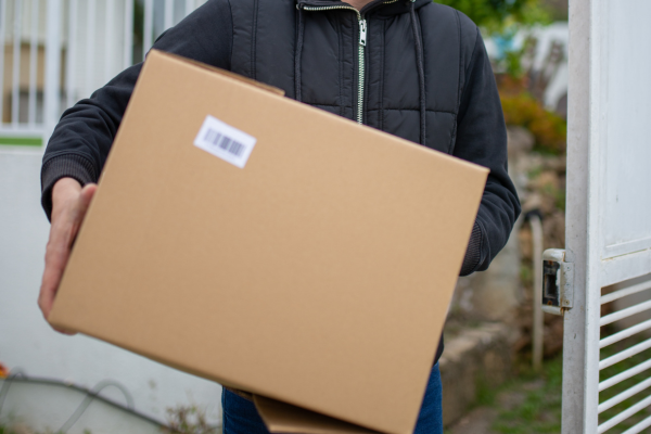 An individual holding a cardboard box