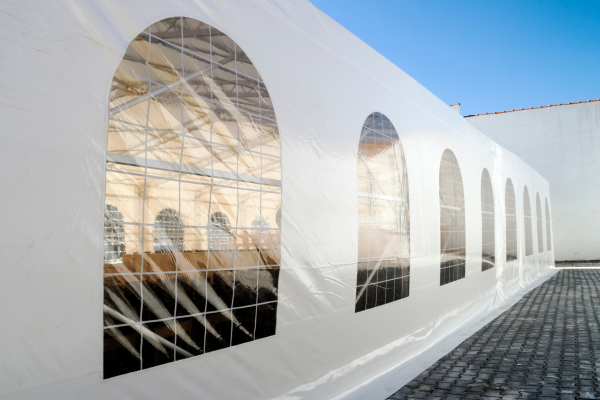 The side of a white party tent on a clear day