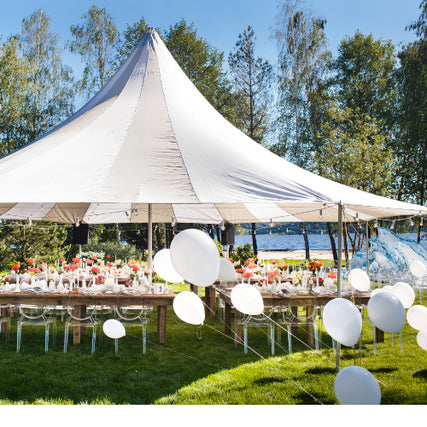 Party & Event RentalsWhite party tent set up outdoors on a clear day with tables and balloons underneath